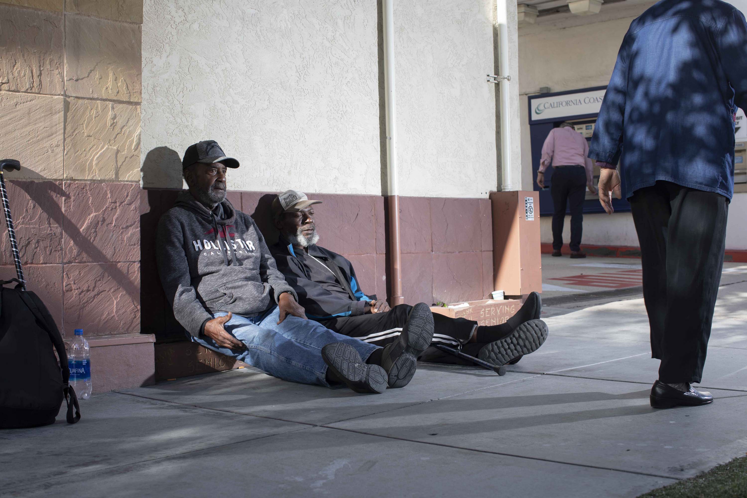 Carl Russell, sitting next to Oscar Walker, a homeless friend from the Gary and Mary West Senior Well Center in downtown San Diego where he sleeps sitting up and often fears being attacked while asleep.